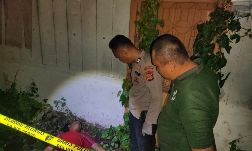 Petugas kepolisian saat melakukan olah tempat kejadian perkara (TKP) di pekarangan rumah kosong di Jalan Putri Rambut Selako, Kelurahan Bukit Lama, Kecamatan Ilir Barat I Palembang, lokasi ditemukannya seorang pria paruh baya dalam kondisi meninggal dunia, Minggu (4/1/2026) malam.